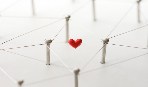 Ein Herz schwebt in einem Netz aus Seilen &uuml;ber der Oberfl&auml;che.